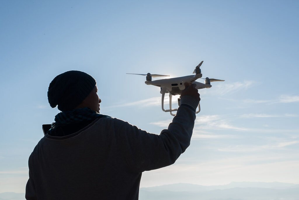 mens hands hold the drone pick it up
